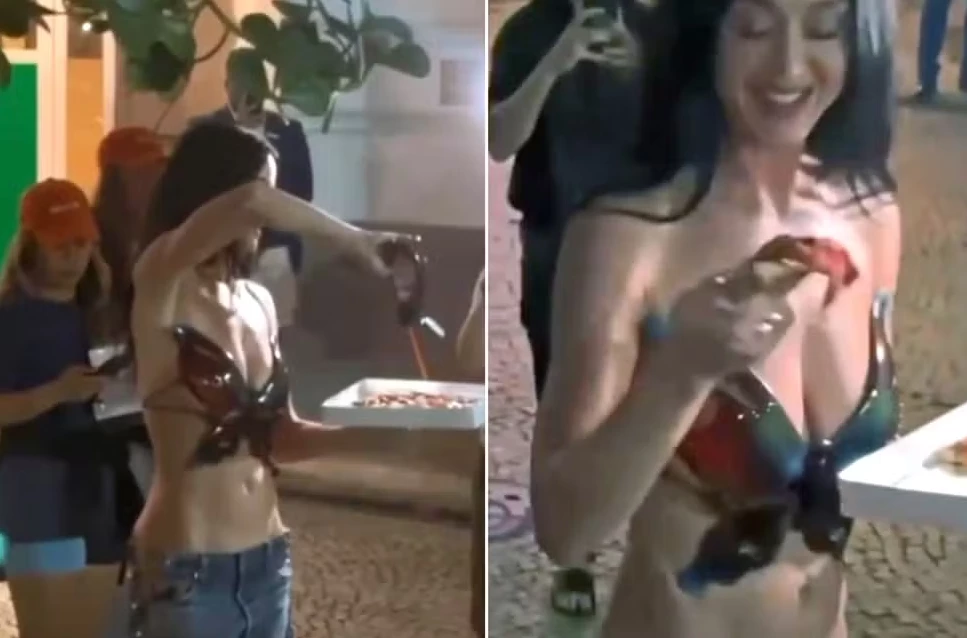 Katy Perry aparece distribuindo pizza para os fãs. (Foto: Reprodução/TV Globo)