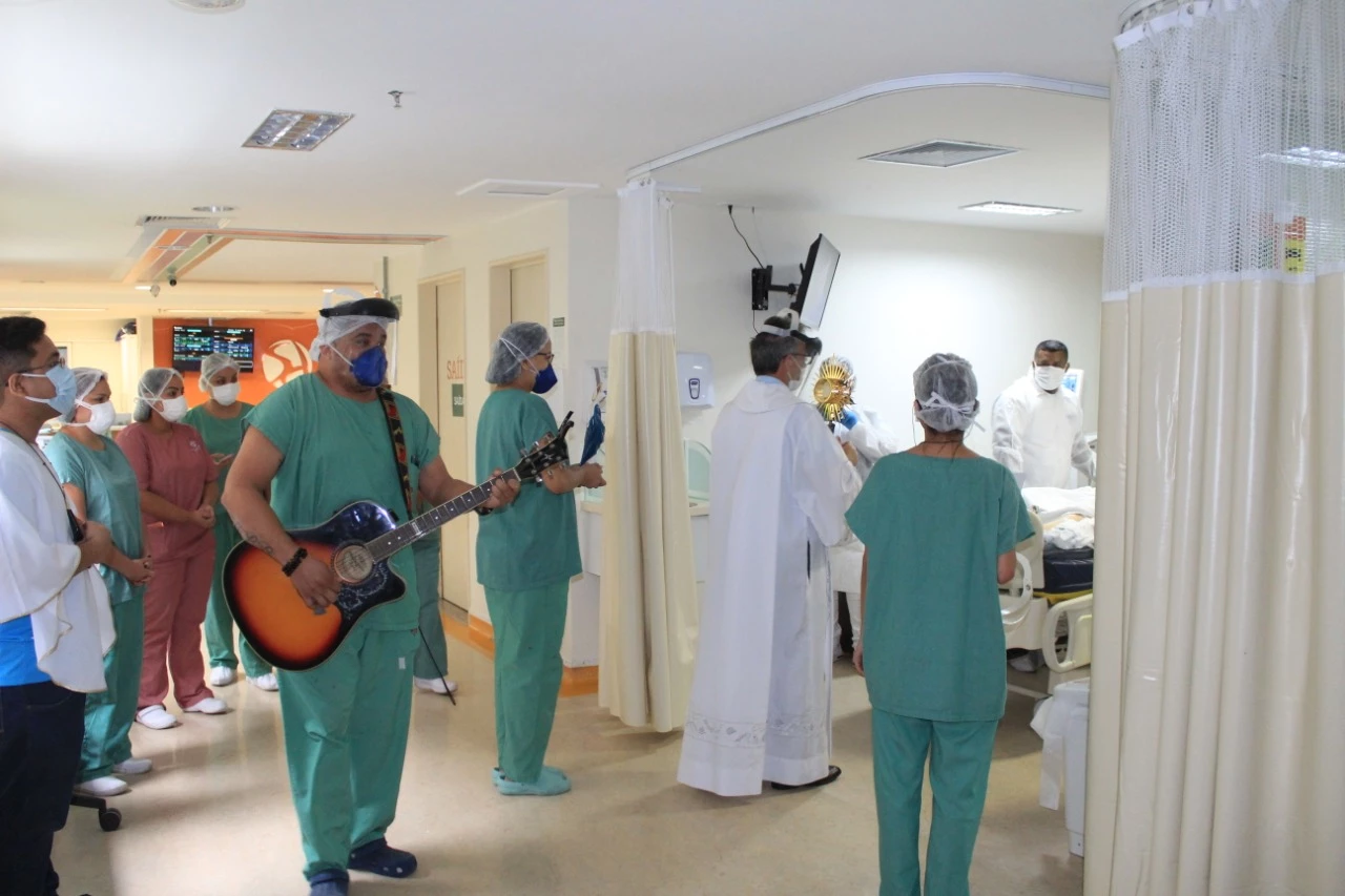 Padre Carlos Martinenghi em momento de fé com pacientes